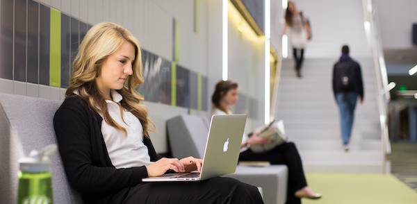Woman using a laptop while seated