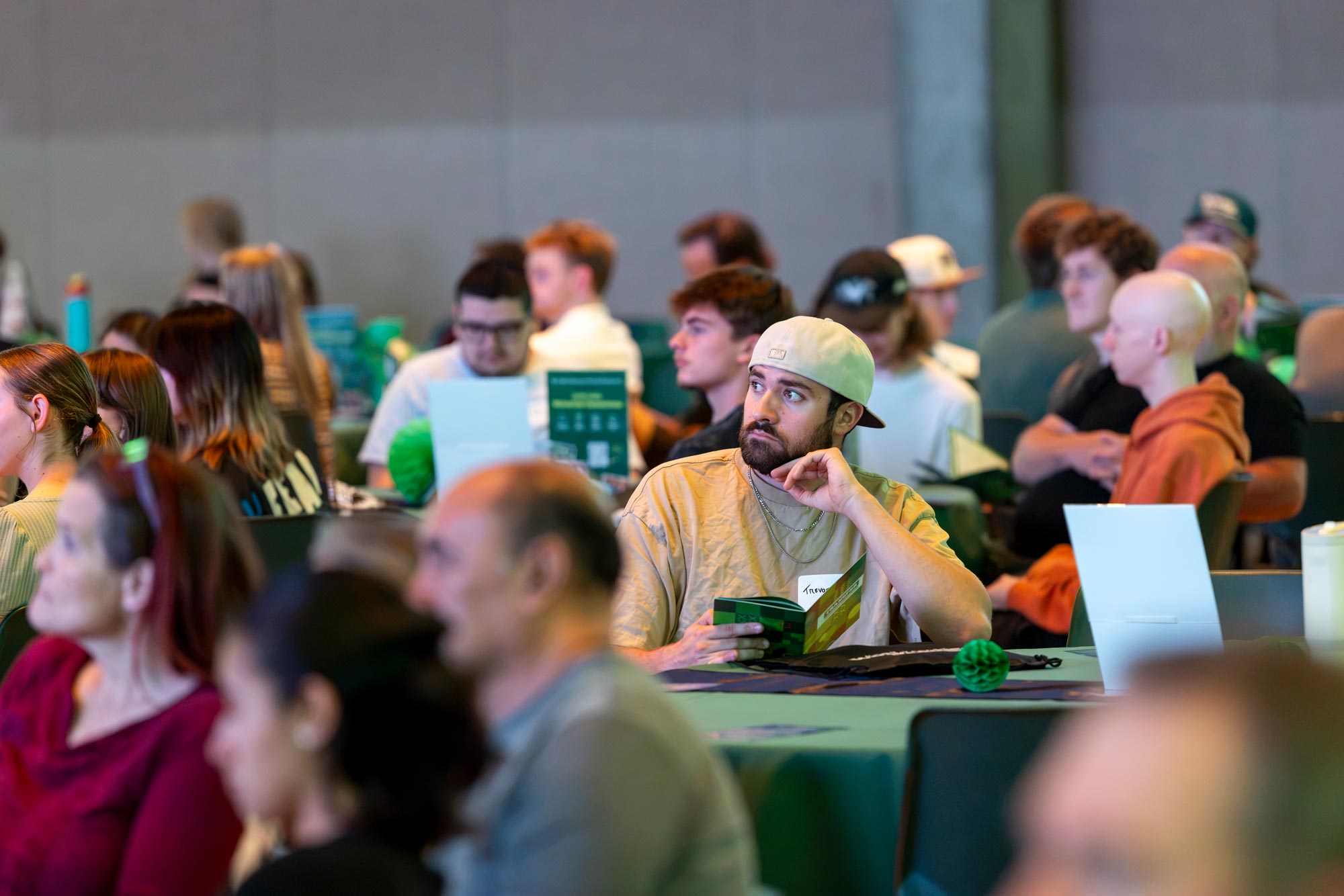 A student sitting at a table looks in front of him.