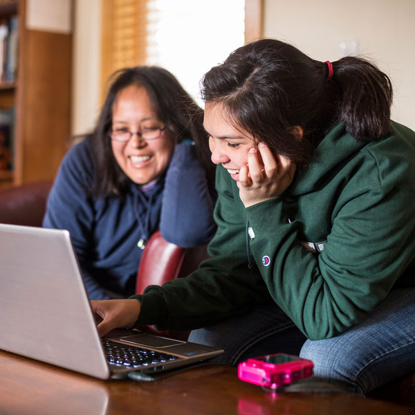 parent and student working on computer