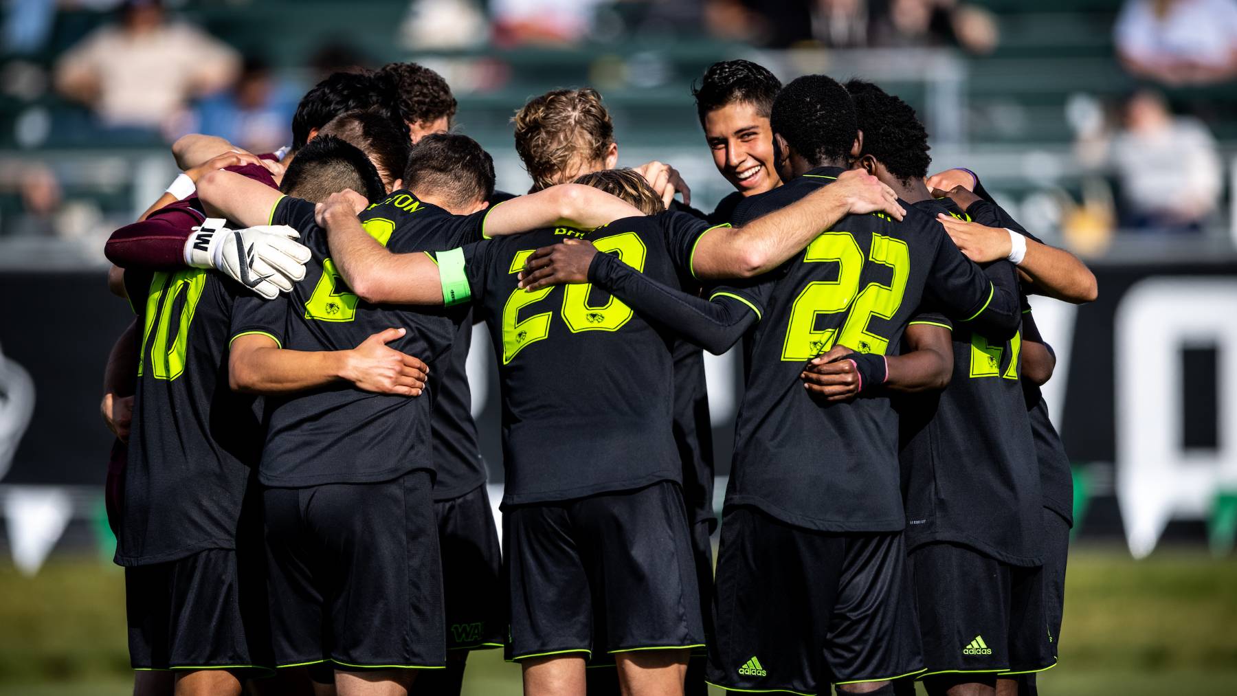 uvu soccer players huddled together