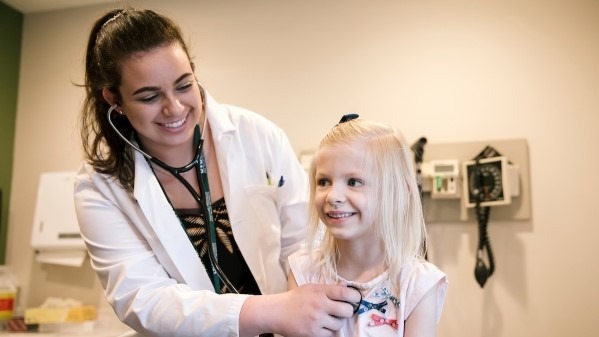 Student checking a childs lungs