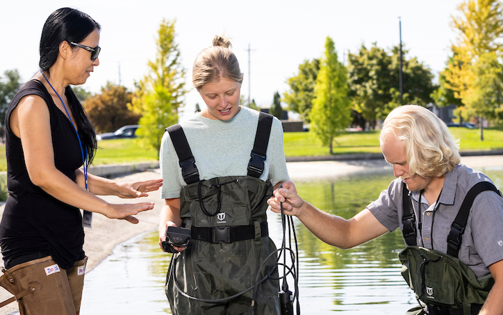 students and proffesor running tests on reservoir water