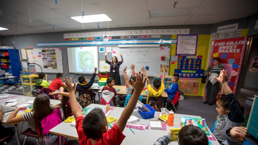 elementary teacher at the front of the class of students