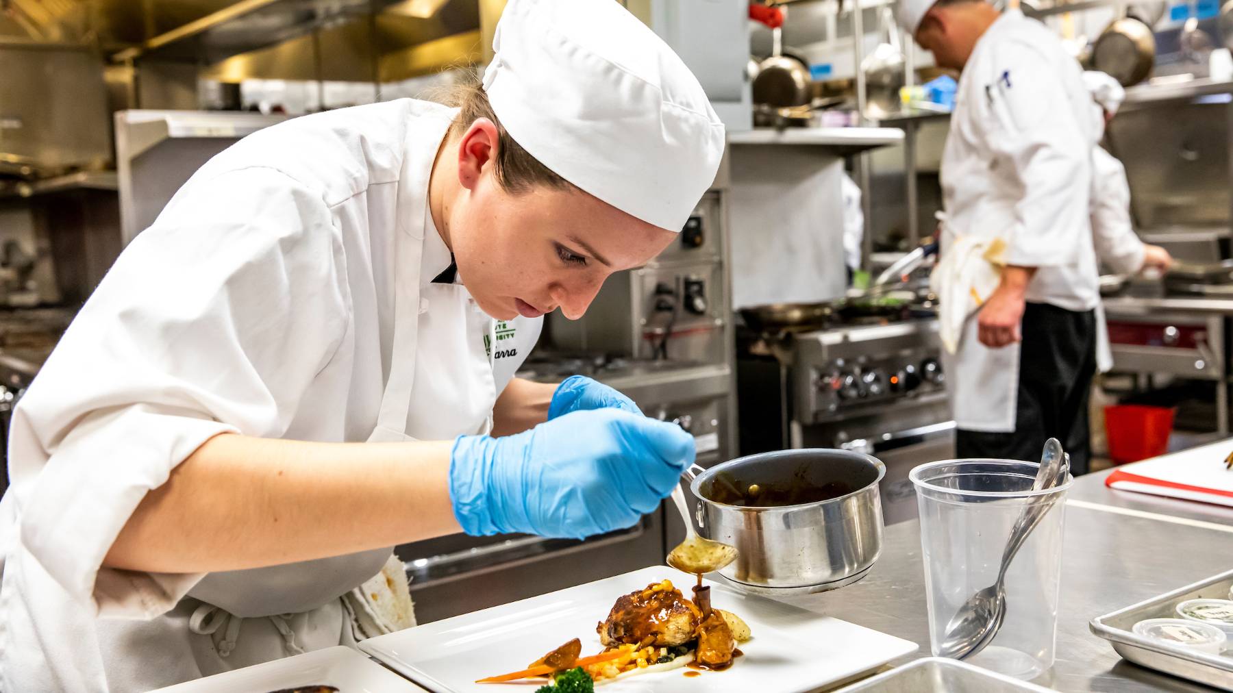 Culinary arts student preparing a plate.