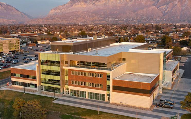 student working on car engine