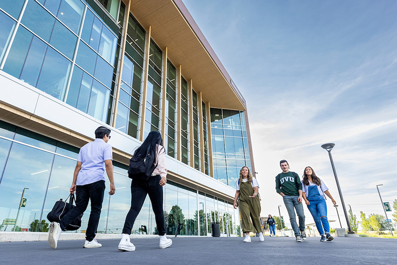 students walking by front entrance of the Keller Building