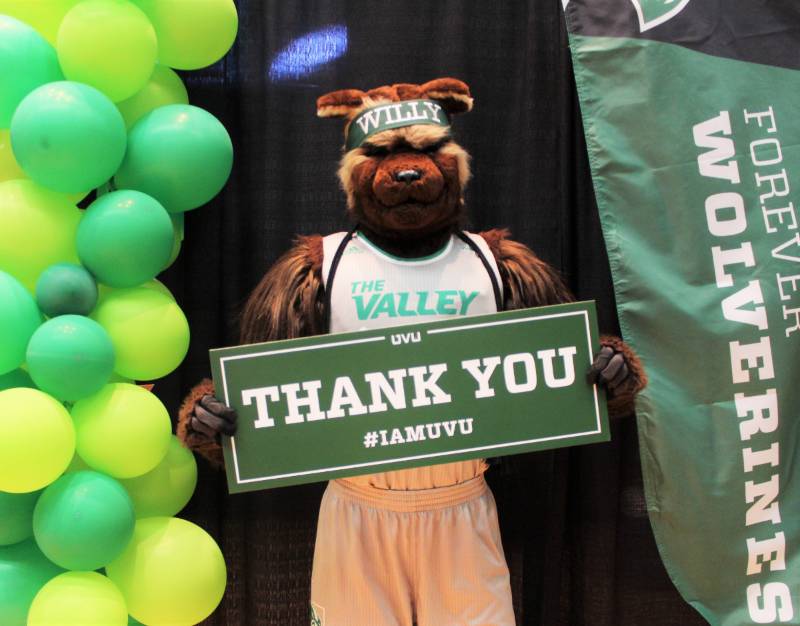 Willy holding up a Thank You sign