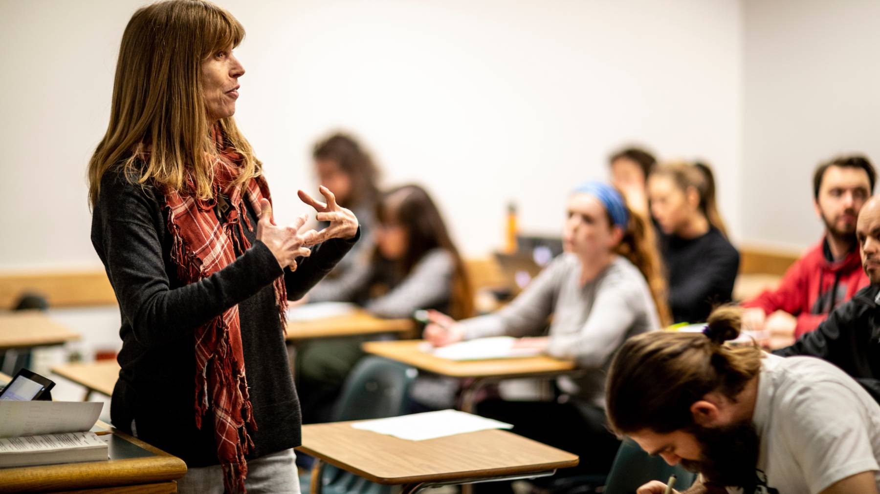 Instructor talking to students in a classroom.