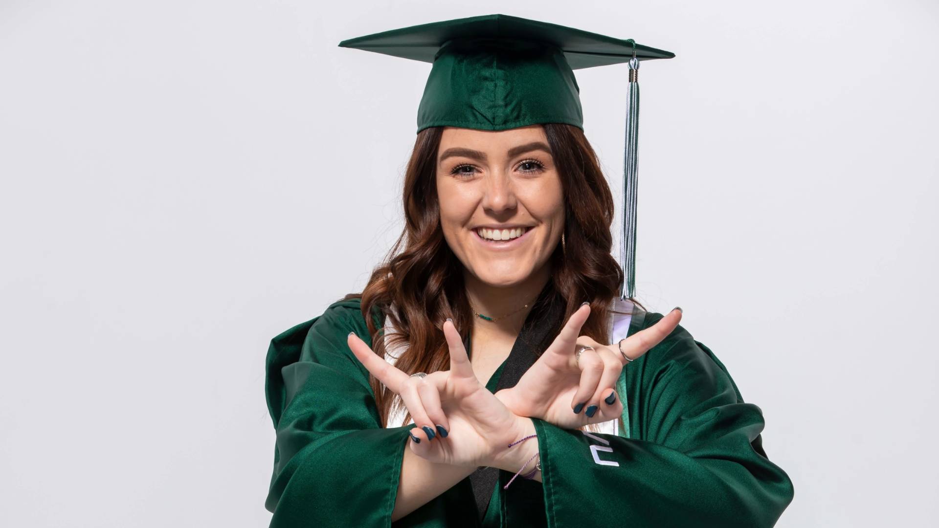 UVU graduate in graduation cap and gown.