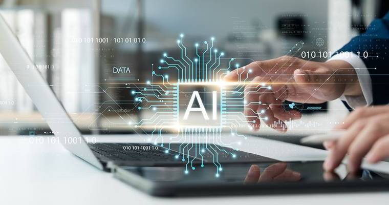Close up of hands working on laptop with AI logo overlaid over it