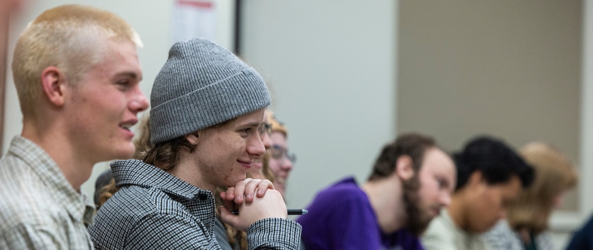 students smiling while sitting in a classroom