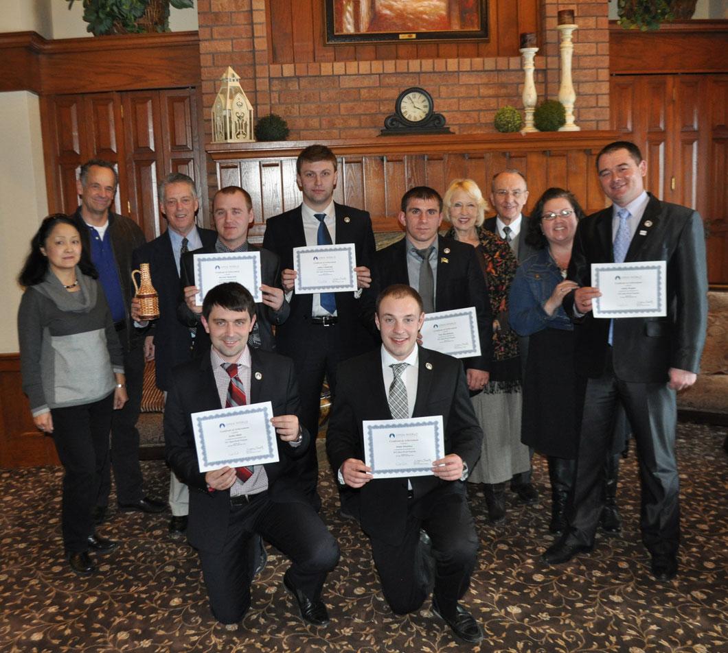 Participants with their Certificates of Completion, Along with Host Families and IA Staff