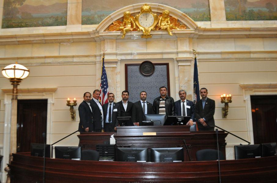 Senator Curt Bramble gives a tour of the Utah State Senate Chambers to delegates