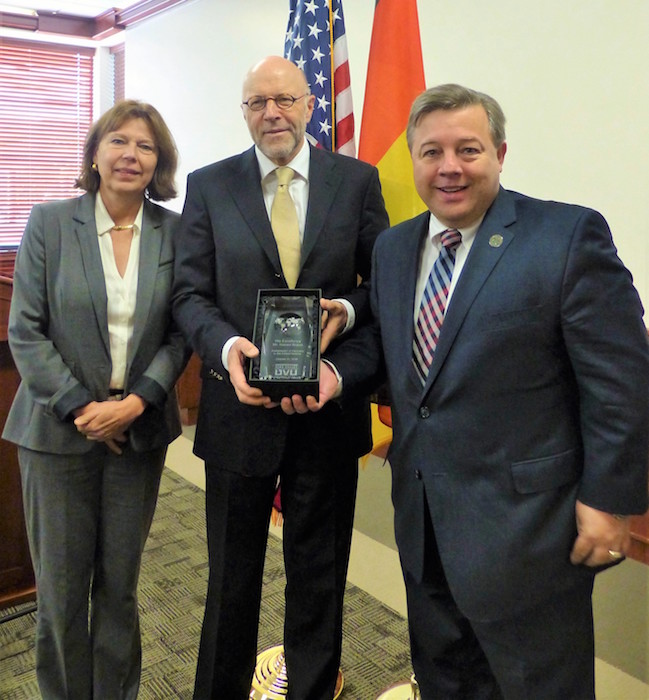 Ambassador Braun is presented with an honorable professor award by Dr. Baldomero Lago. 
