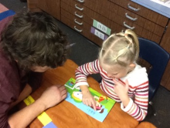 Child with instructor reading a book