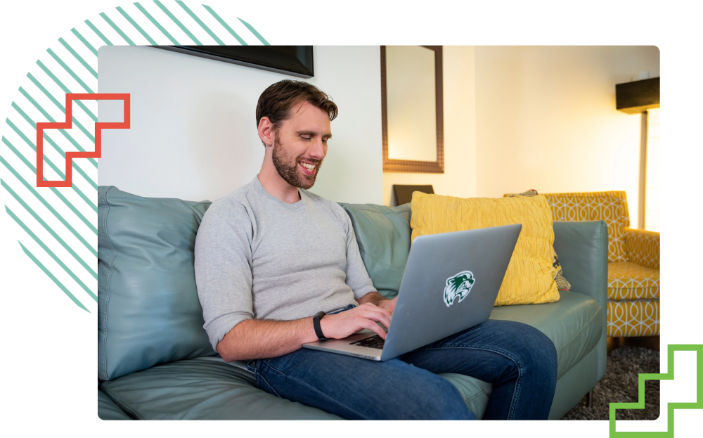 student typing on a laptop