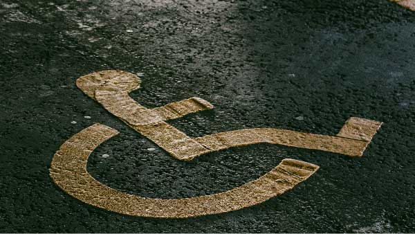 Handicap parking space logo painted on concrete