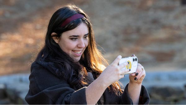 Woman taking a picture with a cell phone