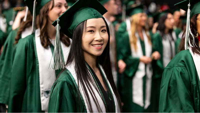Graduates dressed in UVU graduation gowns