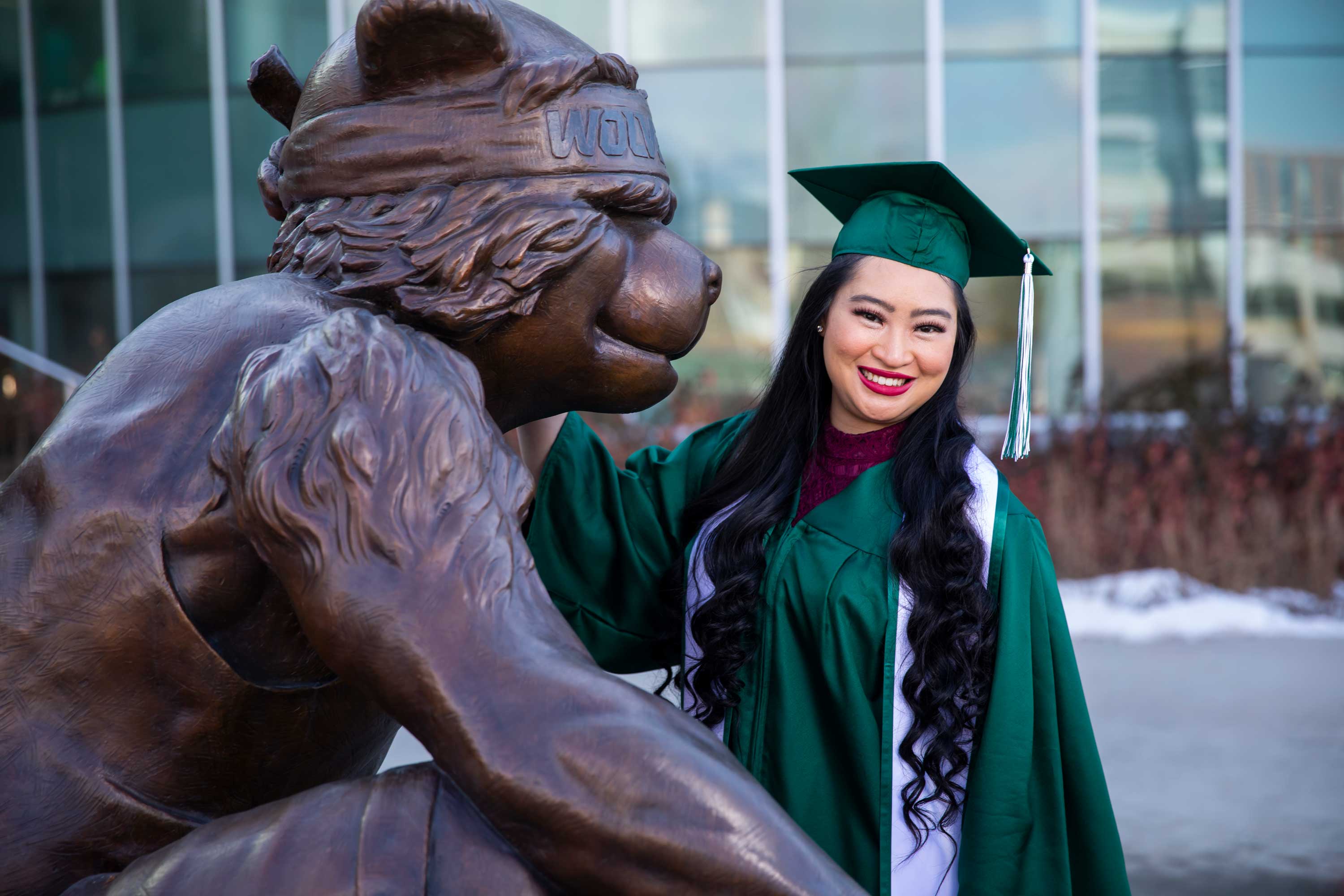 girl standing with the wiley the cyote statue