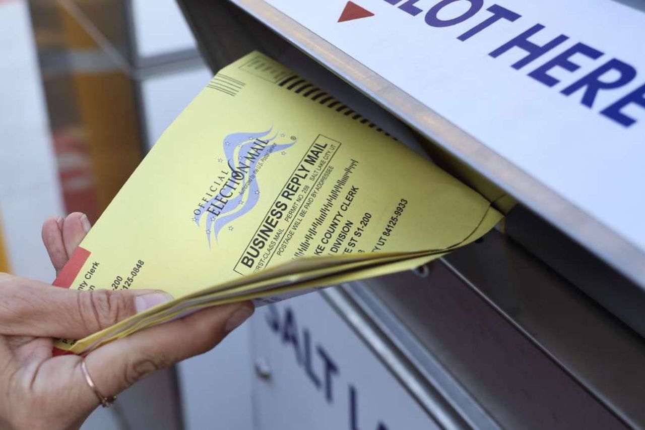 Mail in ballots being placed into county drop boxes