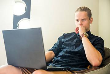 man looking at a laptop