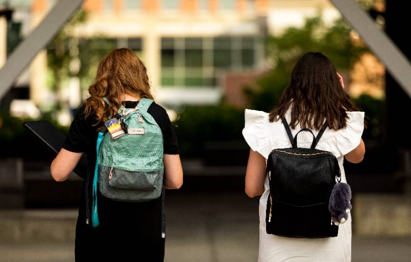 Two women talking on campus