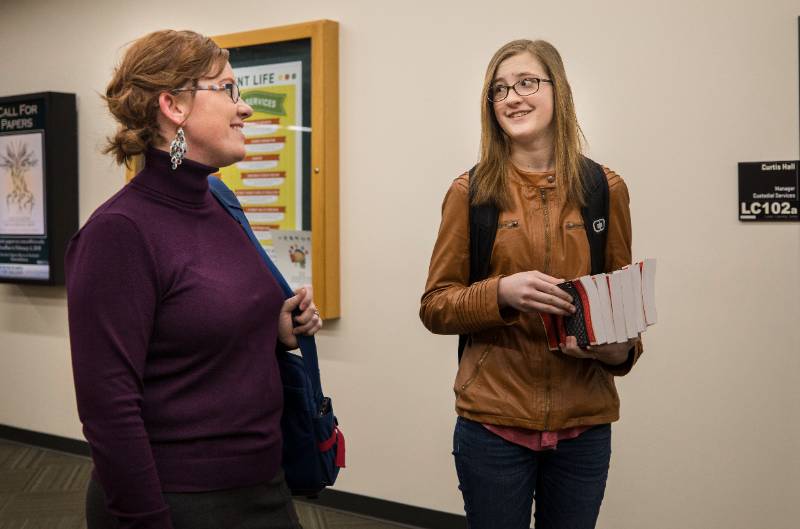 two people walking on campus