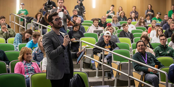 Student speaking in auditorium
