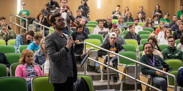 Student speaking in auditorium