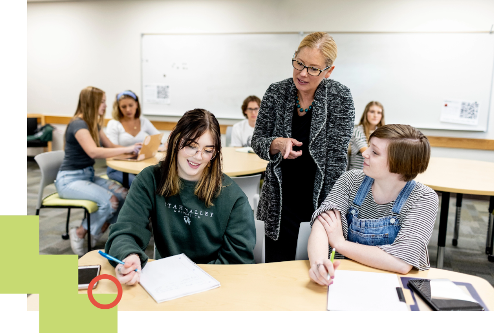 professor helping students in class