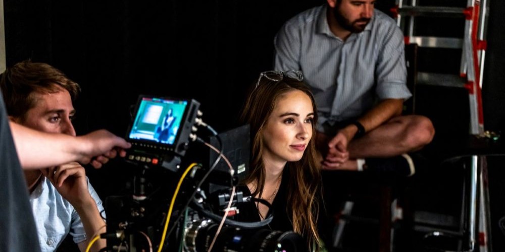 Director shooting a film, a film crew is behind them