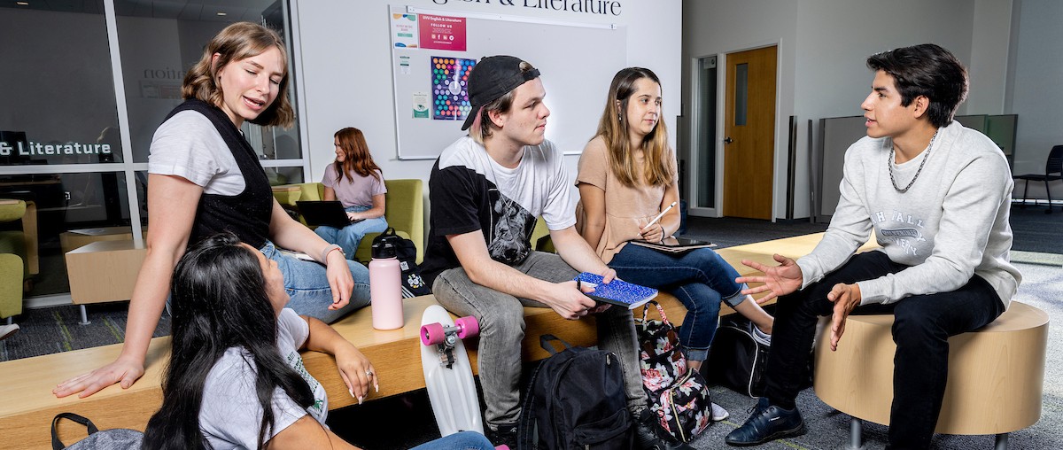 students seated around a study area on campus having a conversation