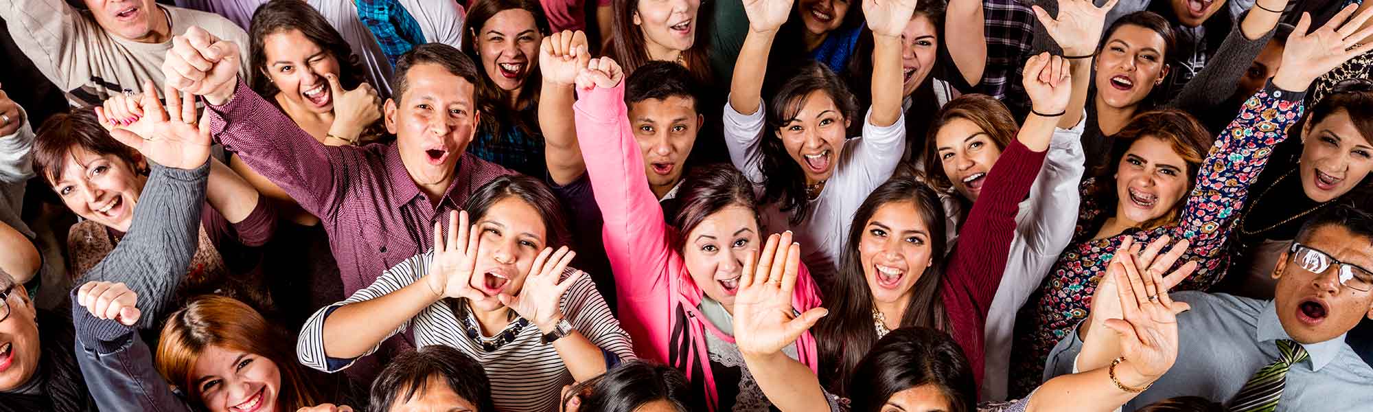 Students looking up at the camera with their hands up