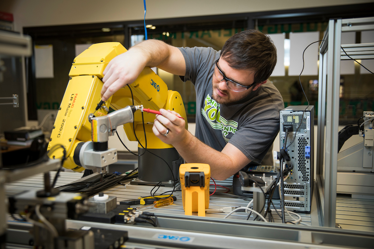 Student working with machinery