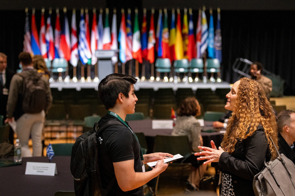 Two students speaking at a conference