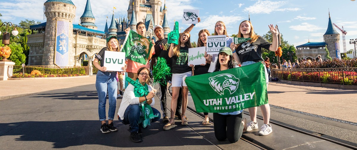 UVU Students posing in front of the Cinderella Castle at Disneyland