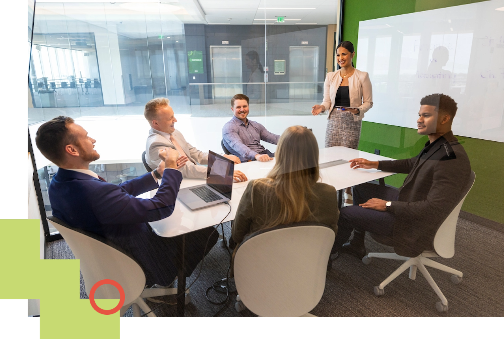 people sat around a table for a meeting