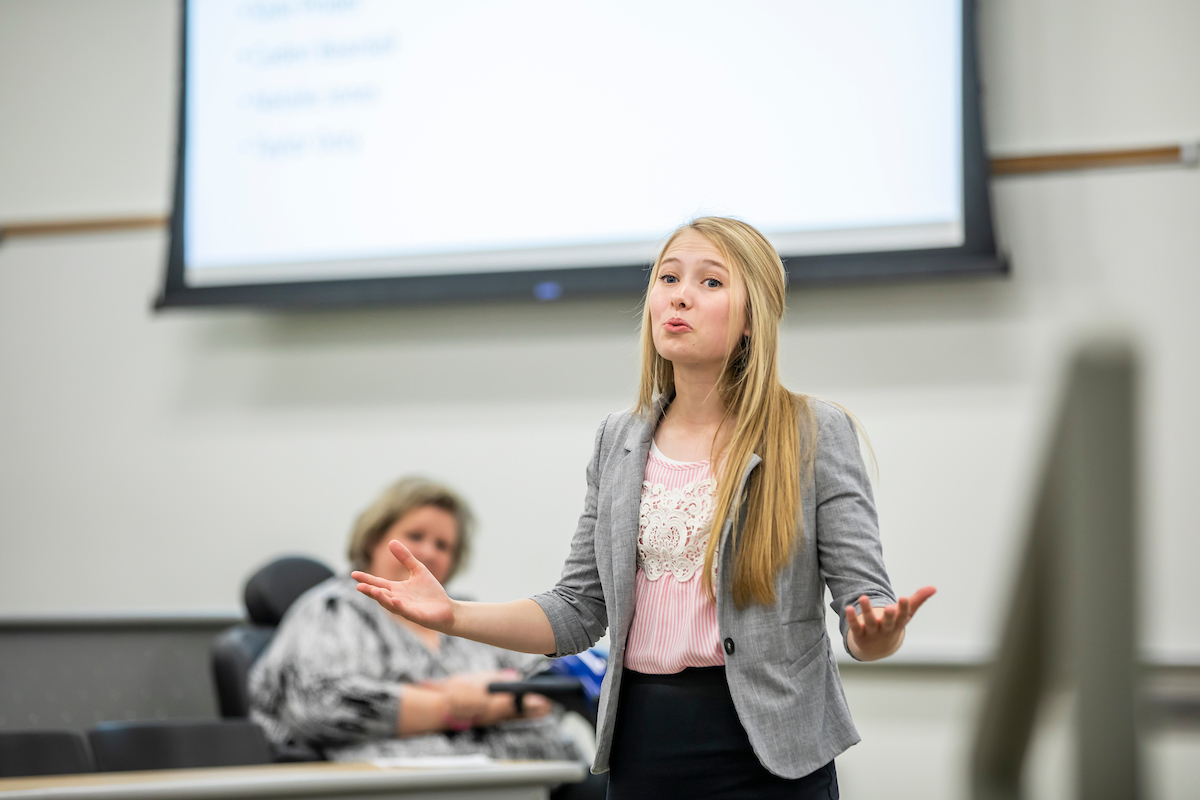 Student presenting in front of classroom