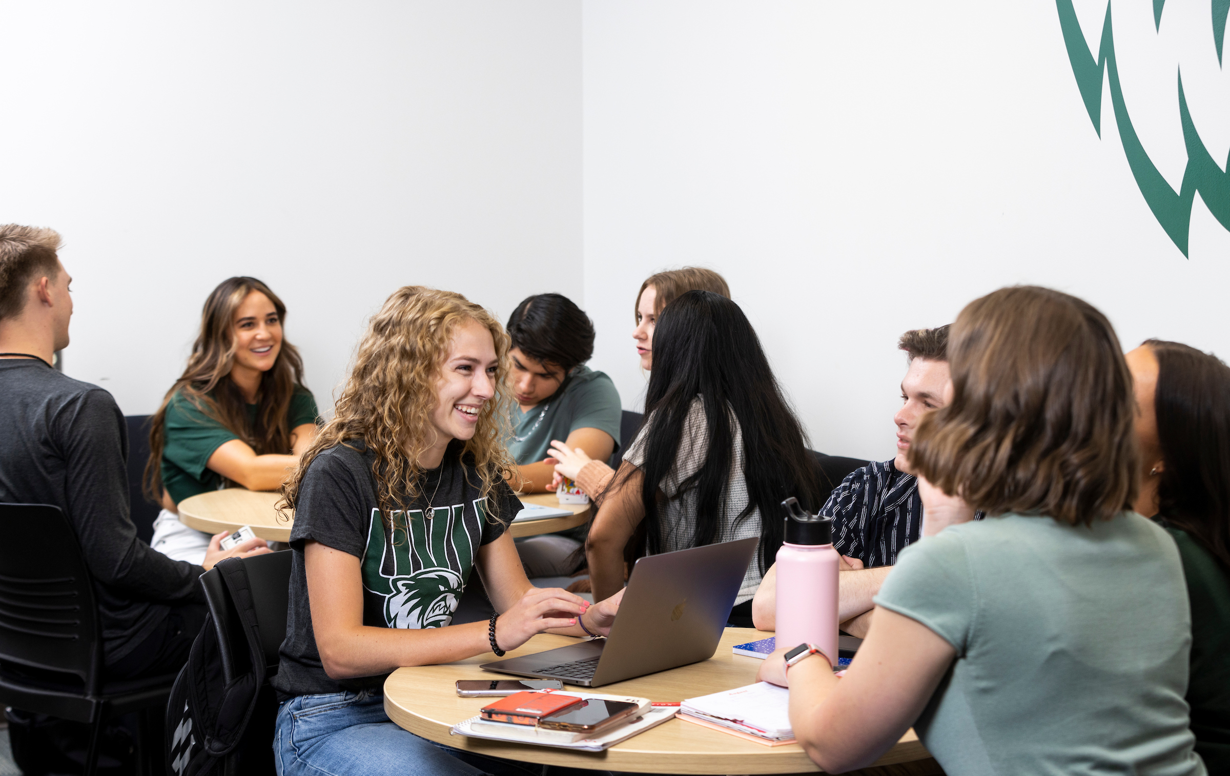 students laughing together while seated in a classroom