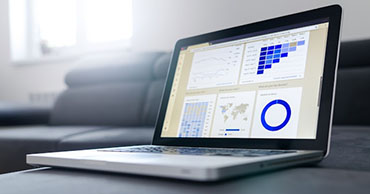 laptop with graphs on screen