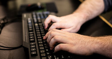 hands typing on a keyboard