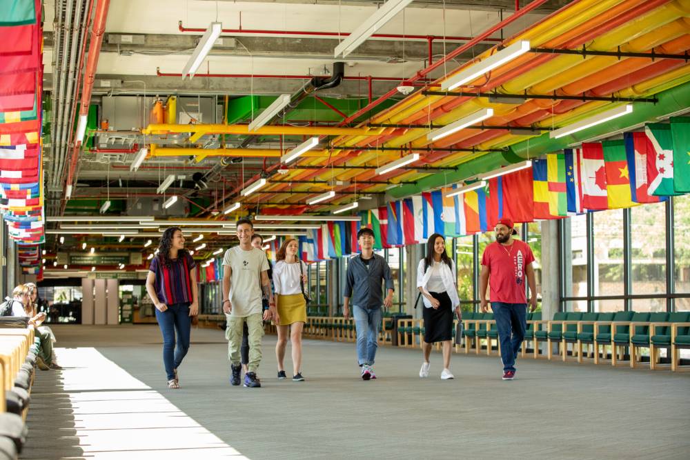 Students walking down the hall of flags