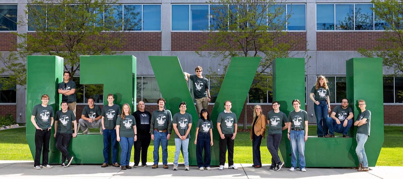 A Russian Studies class in front of the big UVU letters outside