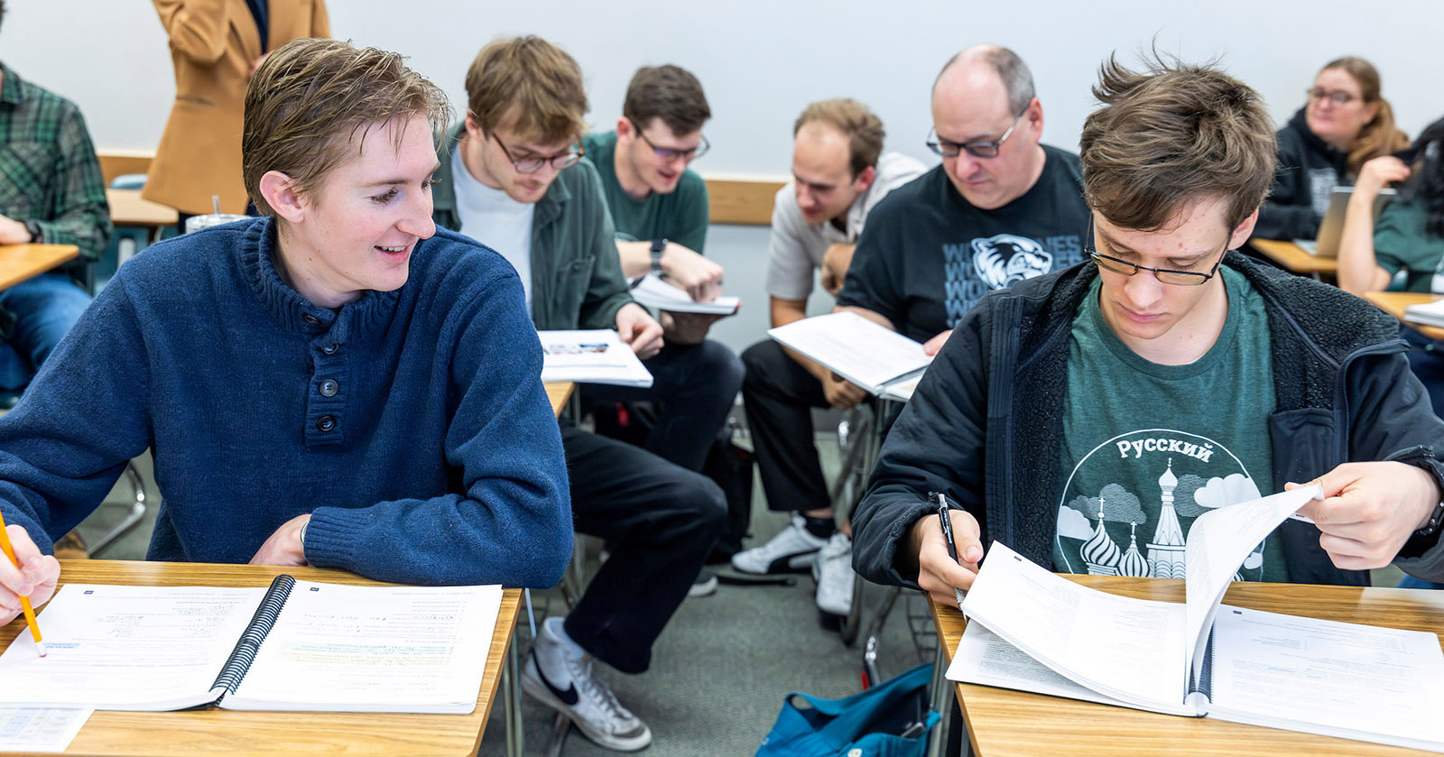 Two Russian Studies students comparing notes in class