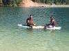 Two students sit on a paddle board