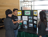 Students talking about their posters