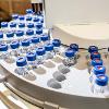 A machine filled with vials sits idle in the forensic lab