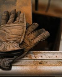 Work gloves and sawdust on the workbench