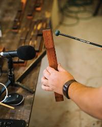 Tracy Furr tests a newly made marimba key for correct sonic properties